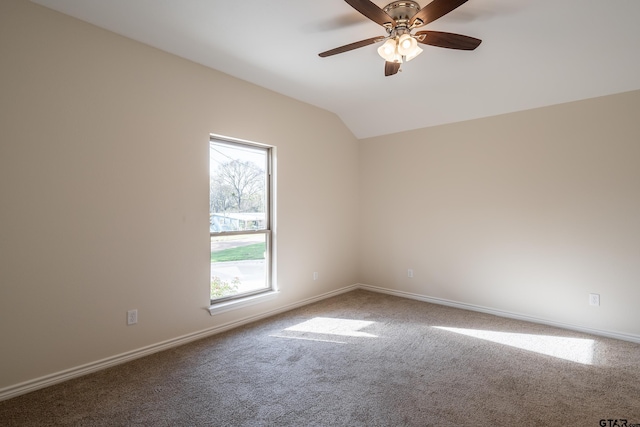 carpeted empty room featuring ceiling fan and vaulted ceiling