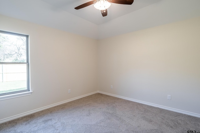 carpeted spare room featuring ceiling fan