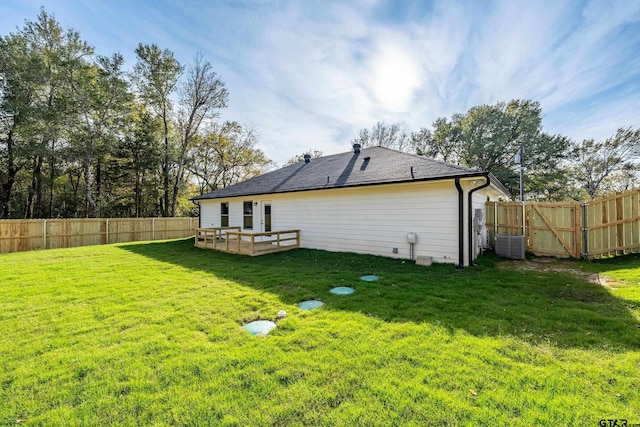 back of house with a yard, a deck, and central air condition unit