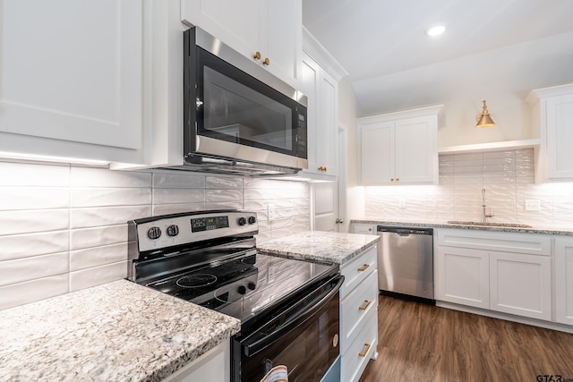 kitchen with white cabinetry, sink, dark hardwood / wood-style floors, decorative backsplash, and appliances with stainless steel finishes