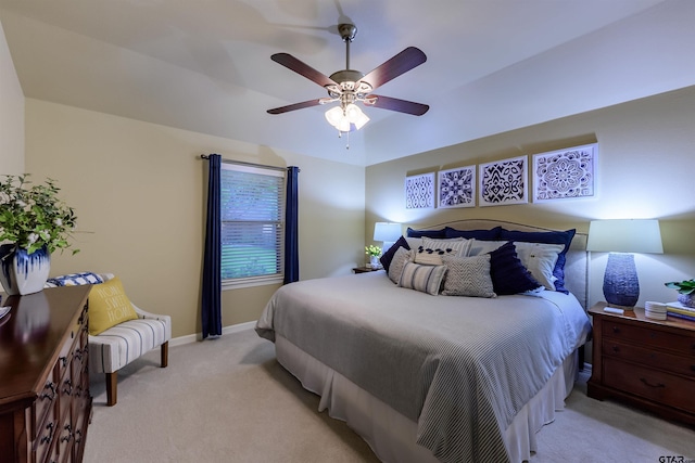 bedroom featuring baseboards, ceiling fan, and light colored carpet
