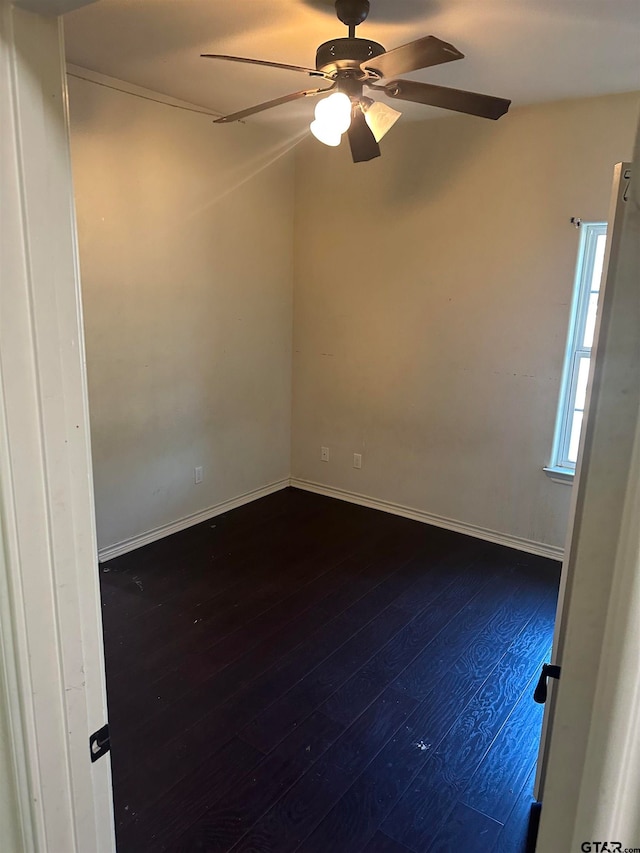 spare room featuring ceiling fan and dark hardwood / wood-style floors