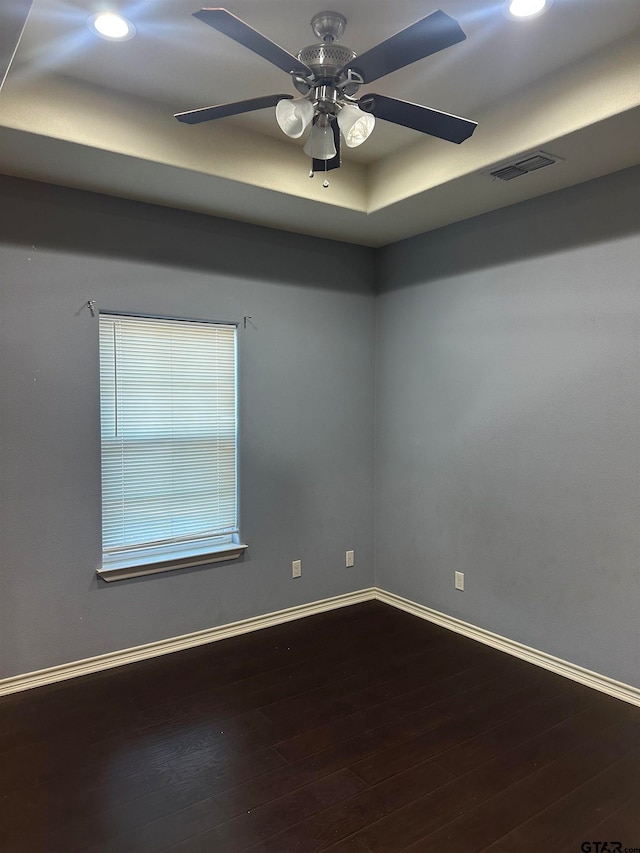 spare room featuring hardwood / wood-style floors and ceiling fan