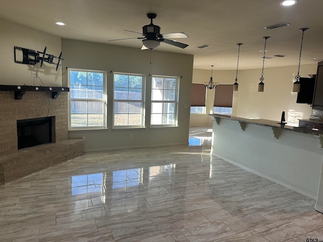 unfurnished living room featuring ceiling fan