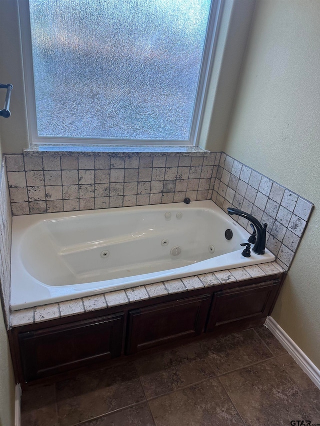 bathroom featuring a tub, tile patterned floors, and a wealth of natural light