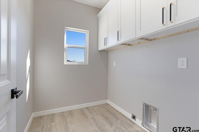 laundry room with light hardwood / wood-style flooring, cabinets, and hookup for an electric dryer