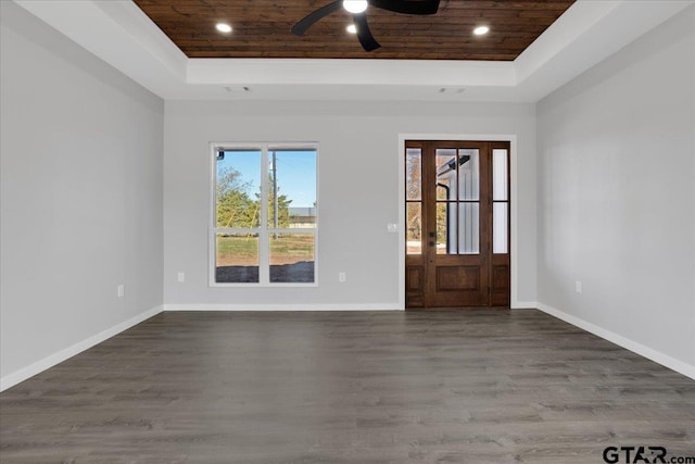 foyer entrance featuring dark hardwood / wood-style flooring, a raised ceiling, ceiling fan, and wooden ceiling