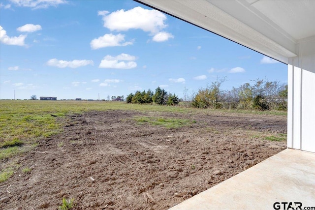 view of yard with a rural view