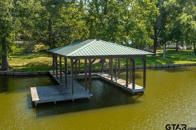 view of dock featuring a lawn, a water view, and a gazebo