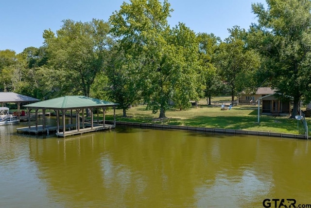 view of dock featuring a yard and a water view