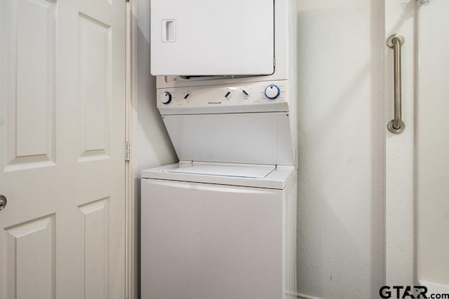 washroom featuring stacked washer and dryer