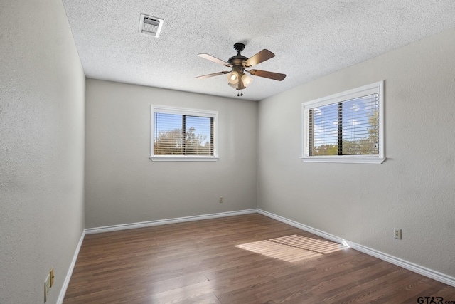 spare room featuring wood-type flooring, a textured ceiling, and ceiling fan