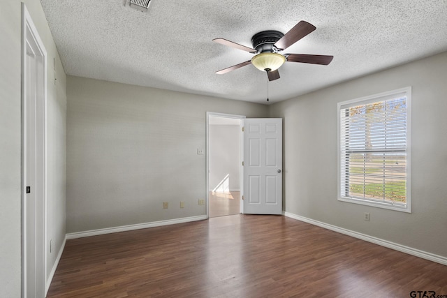 unfurnished bedroom featuring ceiling fan, dark hardwood / wood-style flooring, and a textured ceiling