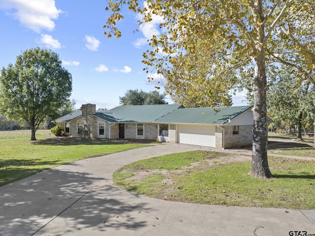 single story home featuring a garage and a front lawn