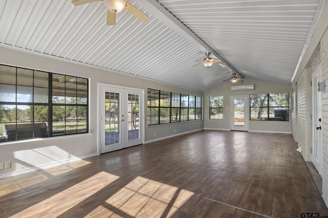 unfurnished sunroom with a wall unit AC, vaulted ceiling with beams, and french doors