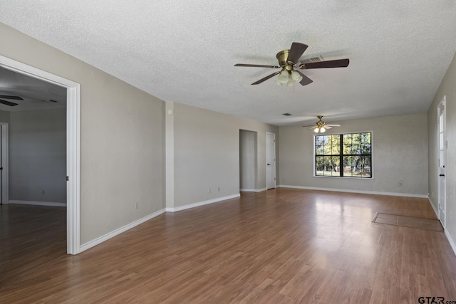 spare room featuring a textured ceiling, dark hardwood / wood-style floors, and ceiling fan