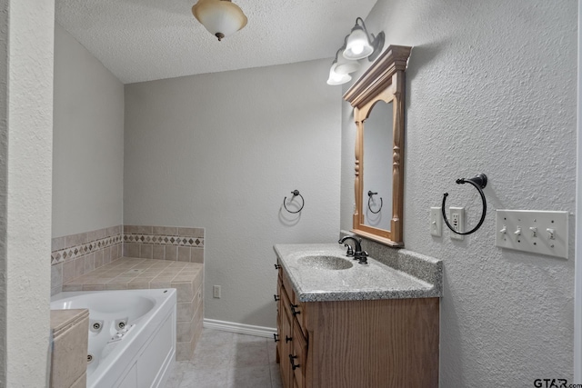 bathroom with a bathtub, vanity, and a textured ceiling