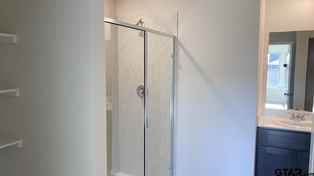 bathroom featuring vanity and an enclosed shower