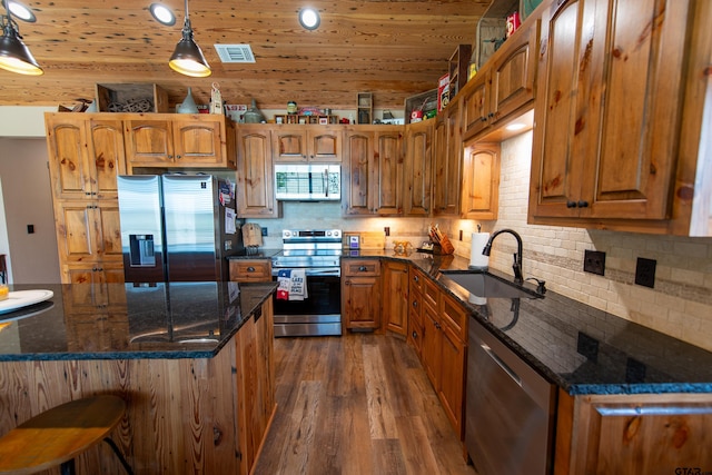 kitchen with sink, hanging light fixtures, wooden ceiling, appliances with stainless steel finishes, and dark hardwood / wood-style flooring