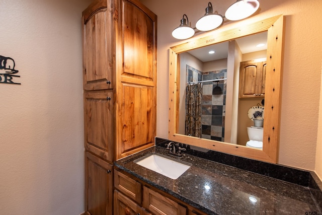 bathroom with vanity, toilet, and curtained shower