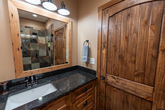 bathroom featuring vanity and a shower with door