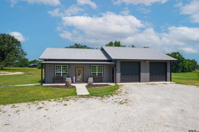 ranch-style house with a garage, a front yard, and covered porch