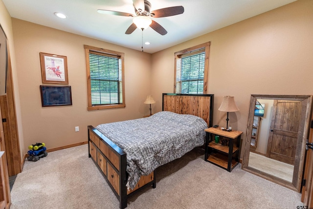 bedroom with ceiling fan and light carpet