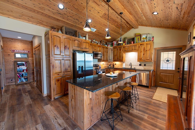 kitchen featuring a kitchen island, appliances with stainless steel finishes, dark hardwood / wood-style floors, sink, and beam ceiling