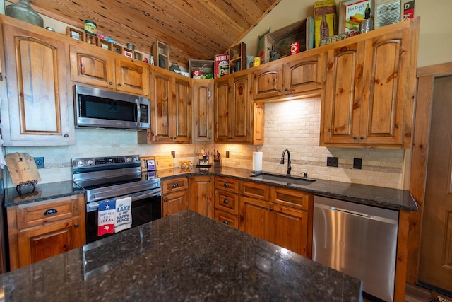 kitchen with vaulted ceiling, appliances with stainless steel finishes, tasteful backsplash, sink, and wood ceiling