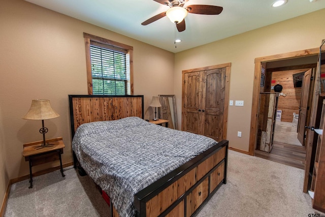 bedroom with a closet, ceiling fan, and carpet flooring