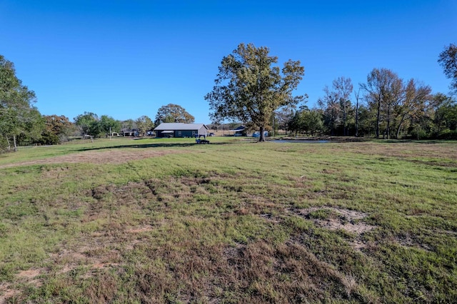 view of yard with a rural view