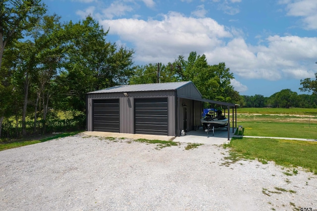 garage with a carport and a yard