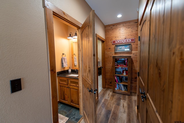 hallway with dark wood-type flooring and sink