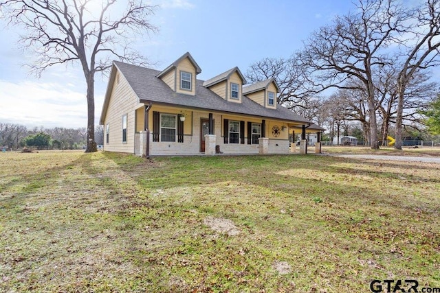 cape cod home with a porch and a front lawn