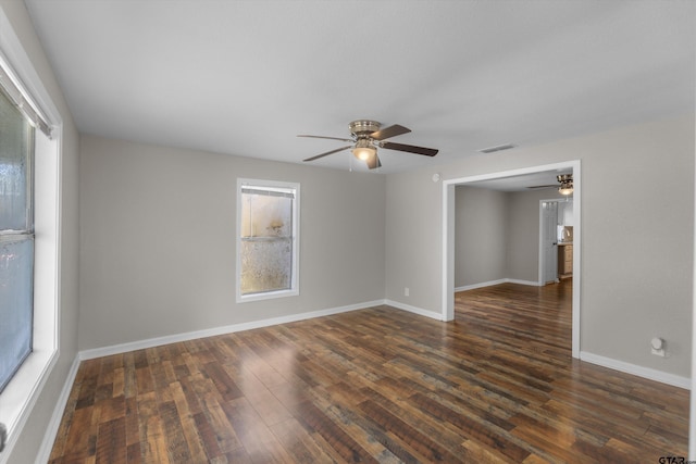 3019 N Grand Ave, Tyler, TX 75702 - unfurnished room with a ceiling fan, dark wood-style floors, and baseboards