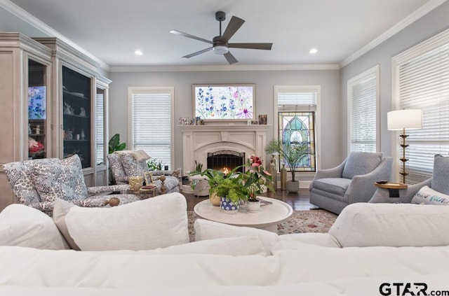 7417 Princedale, Tyler, TX 75703 - living area featuring a ceiling fan, wood finished floors, a warm lit fireplace, crown molding, and recessed lighting
