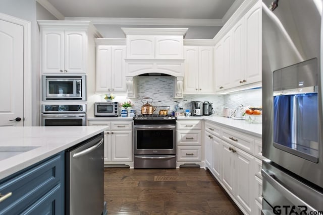 7417 Princedale, Tyler, TX 75703 - kitchen with stainless steel appliances, white cabinets, light countertops, and ornamental molding