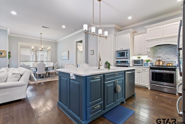 7417 Princedale, Tyler, TX 75703 - kitchen with blue cabinets, a chandelier, white cabinetry, light countertops, and appliances with stainless steel finishes