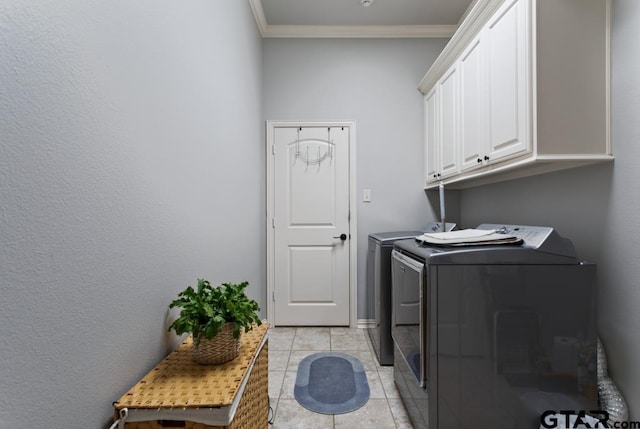 7417 Princedale, Tyler, TX 75703 - laundry area featuring washer and clothes dryer, cabinet space, crown molding, and light tile patterned floors