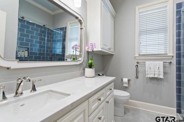 7417 Princedale, Tyler, TX 75703 - full bathroom featuring vanity, a tile shower, crown molding, and healthy amount of natural light