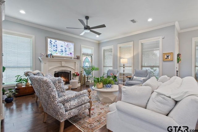 7417 Princedale, Tyler, TX 75703 - living room featuring ceiling fan, a warm lit fireplace, dark wood-style floors, recessed lighting, and ornamental molding