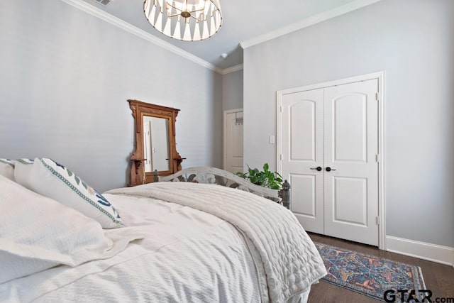 7417 Princedale, Tyler, TX 75703 - bedroom featuring ornamental molding, a chandelier, dark wood-style floors, and a closet