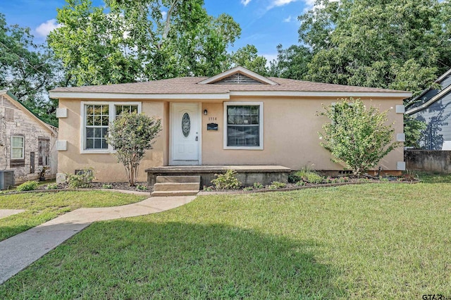 view of front of house featuring central AC unit and a front lawn