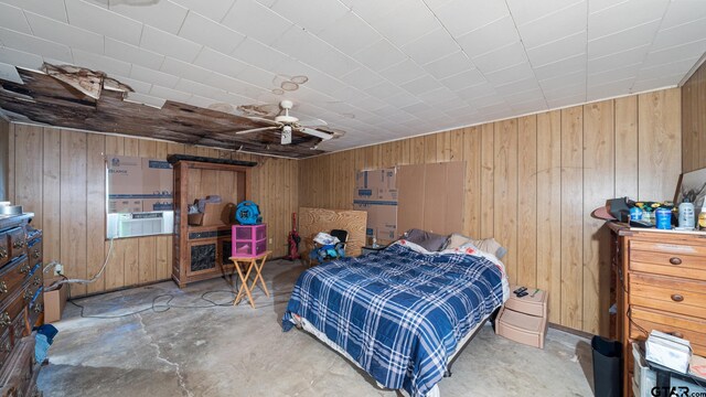 bedroom with wooden walls, cooling unit, and concrete floors