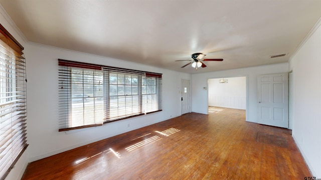 spare room with ceiling fan, crown molding, and wood-type flooring