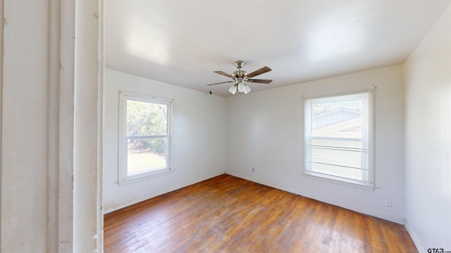 unfurnished room with wood-type flooring and ceiling fan