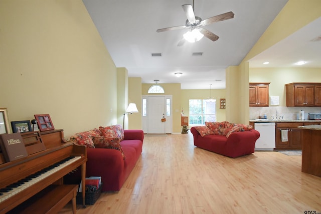 living area featuring light wood-type flooring, ceiling fan, a chandelier, recessed lighting, and lofted ceiling