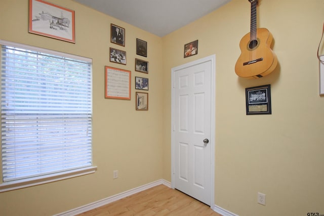 spare room with light wood-type flooring and baseboards