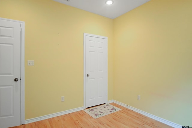 spare room with light wood-style flooring, baseboards, and recessed lighting