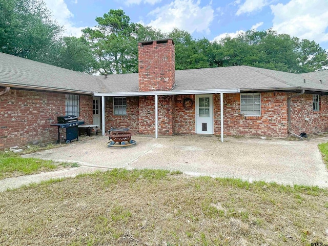 back of property with a patio area and a yard